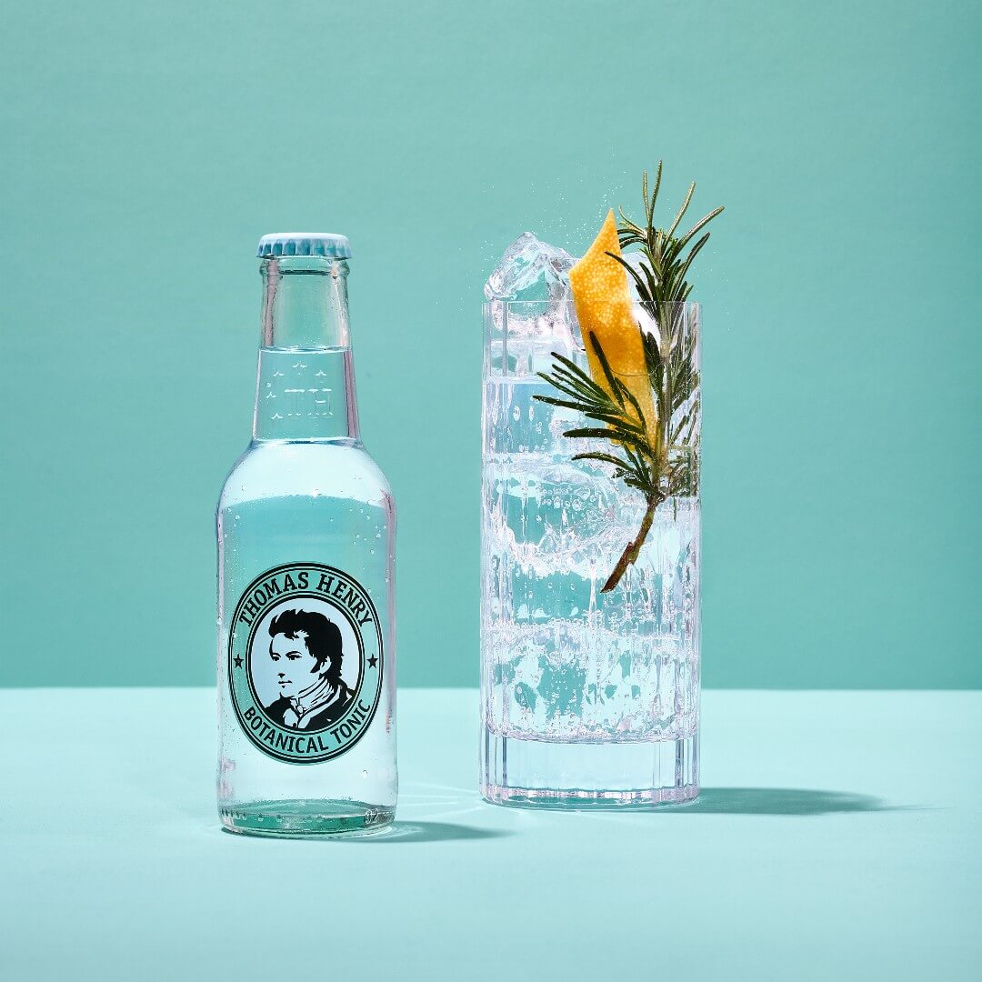 Thomas Henry Botanical Tonic bottle beside a gin and tonic