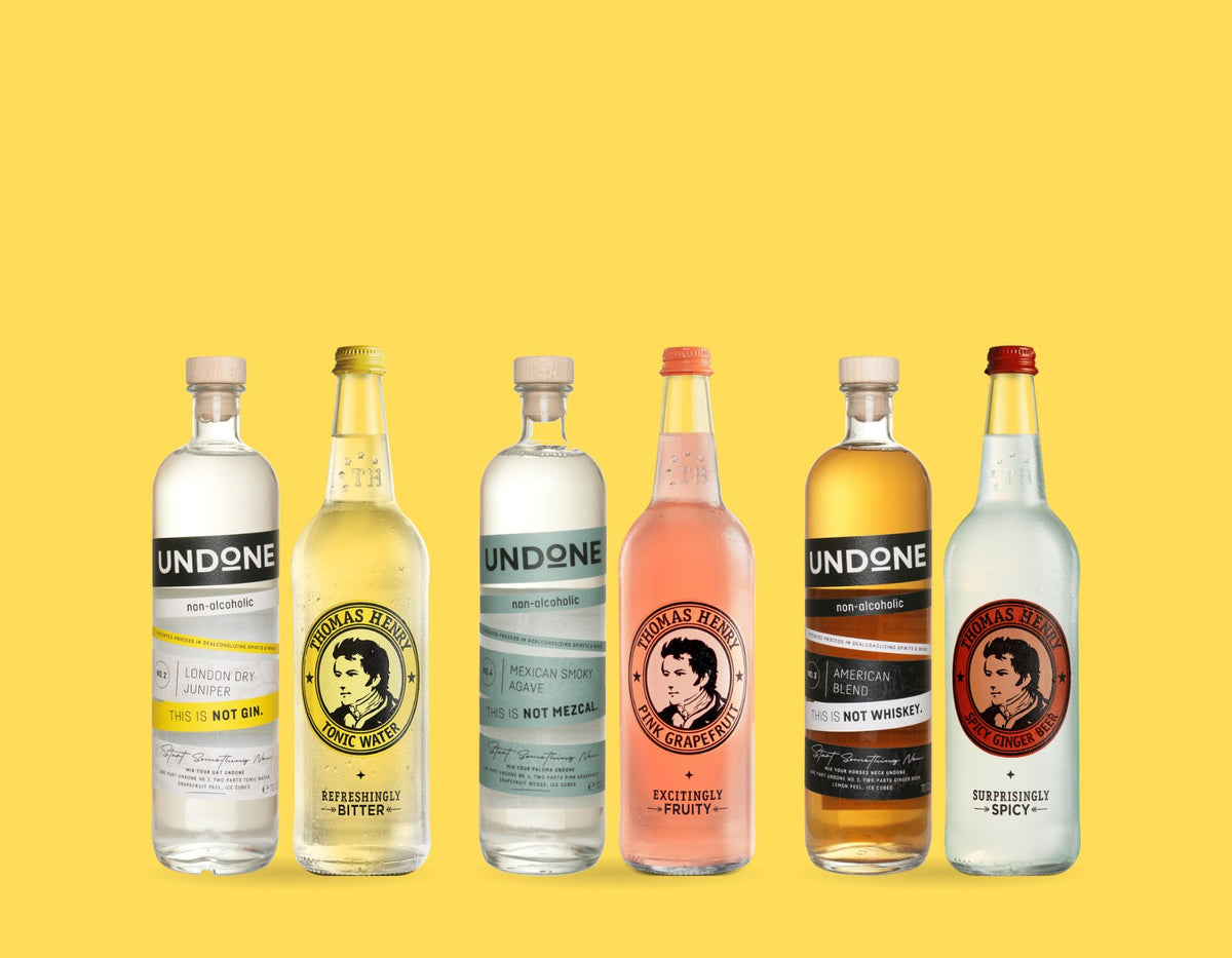 Three UNDONE bottles with Thomas Henry 750ml mixers on yellow